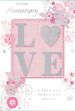This softly romantic anniversary card feels like a gentle celebration of enduring love, as if chosen on a leisurely stroll past the independent shops of Herne Hill. The design blends pastel pinks, muted mauves, and silvery greys, creating a hush of intimacy and warmth. At the centre, the word LOVE appears in raised, velvety glitter, each letter softly luminous, with the O replaced by a shimmering silver heart that stands out as a tiny, tactile focal point. This heart seems almost like a small keepsake nestled into the paper, inviting touch as much as sight. Around the central word, delicate blossoms in blush and mauve stretch outward, their petals painted with a watercolour softness that suggests gentle movement, like flowers nodding in a light breeze over Brockwell Park. Slender stems and trailing vines are drawn in fine, flowing lines that weave gracefully between the blooms, creating a sense of lightness and care that mirrors the craft of a local florist preparing an anniversary bouquet for delivery across Herne Hill. Scattered among the flowers are small flourishes-tiny petals, elegant swirls, and subtle butterflies-that add a quiet whimsy, evoking an English spring garden after a soft rain. The background shifts from palest pink to near white, framing the design with space and calm. Above the floral motif, On Our Anniversary is scripted in refined, understated lettering, while below, the promise I love you today and always is written in a gentle, flowing script. The whole card feels like a tender keepsake, ideal for marking a shared journey in Herne Hill with a gesture as soft as a whisper yet full of heartfelt meaning.